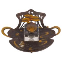 G E SCHULTZ - a stylised Art Nouveau painted metal deskstand with fitted glass inkwell, W23cm,