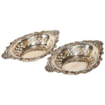 A pair of George V silver dishes, with scrolled embossed and pierced decoration, L17cm, maker's