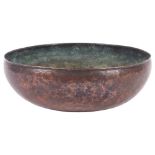 An Arts and Crafts hammered copper bowl, by Hugh Wallis, with monogram HW to the underside, diameter