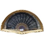 Antique lace fan with pierced and gilded sticks, mounted in gilt-framed display case, W51cm