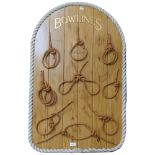 A display of bowline knots, mounted on wooden panel with rope twist border, H96cm