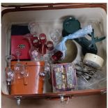 A suitcase containing kitchen scale and weights, clock, binoculars, glassware and a jewellery