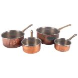 A graduated set of 4 copper saucepans with brass handles, largest diameter 20cm