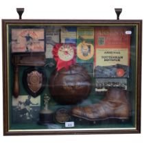 A framed and glazed montage of football memorabilia, including Antique rattle, whistle, leather