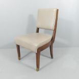 An Art Deco style leather upholstered side chair with brass feet.