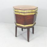A George III octagonal brass bound mahogany wine cooler on stand. 50x70x46cm.