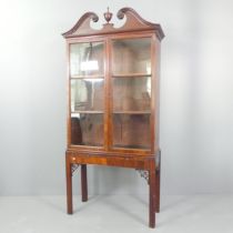 A 19th century mahogany bookcase on stand in three sections, with two glazed doors, two adjustable