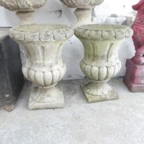 A pair of weathered concrete campana style urns. 43x58cm Good condition. These are modern pieces, in