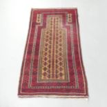 A red-ground Persian prayer rug. 170x90cm.