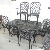 A painted metal garden table with pierced geometric pattern to top and label for Nova,