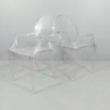 A pair of Louis Ghost stacking chairs, by Philip Starck for Kartell.