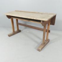 An early 20th century oak double school bench. 107x60x39cm.