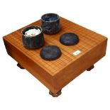 A wooden Go board, 45x26x40cm. and 2 pots of black and white counters.