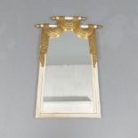A large mid-century Hollywood Regency painted and gilded wood and gesso mirror with simulated swag