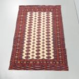 A red and cream-ground Tekke rug. 182x123cm.