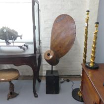A propeller design sectional stained pine sculpture on stand, with plaque, which reads 'P.A.L - 24/