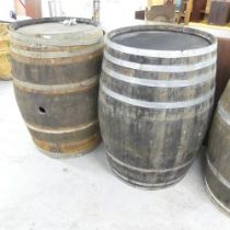 A matched pair of vintage coopered oak barrels. 75x100cm. One loose band. One labelled Ramoneda