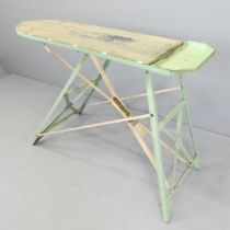 A mid-century ironing board, with paper label for Fab-Ware, by PTP ltd. 120x79x47cm.