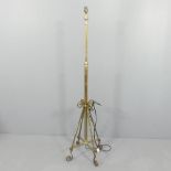 An antique brass standard lamp, with rise and fall mechanism. Height 147, rising to 166cm.
