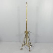 An antique brass standard lamp, with rise and fall mechanism. Height 147, rising to 166cm.