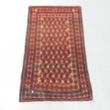 A red-ground Turkmen rug. 143x84cm.