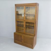 ESAVIAN - A mid-century oak sectional stacking bookcase in four sections, two having two glazed