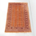 A red-ground Bokhara rug. 188x126cm. Generally good condition. Loss to fringe.