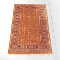 A red-ground Bokhara rug. 188x126cm. Generally good condition. Loss to fringe.