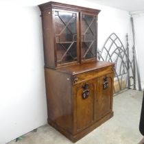 An antique mahogany two-section bookcase on cabinet, the base having a single frieze drawer and