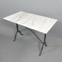 A rectangular marble-top garden table on cast iron base. 100x70x50cm.