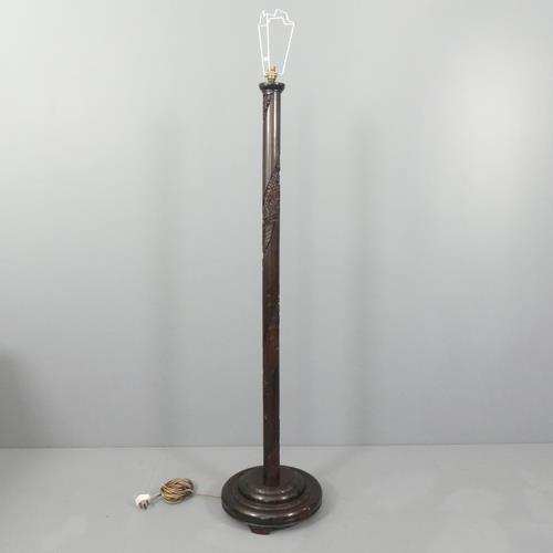 A modern Chinese mahogany standard lamp with carved decoration and pedestal base. Height to