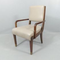 An Art Deco style leather upholstered desk armchair with brass feet.