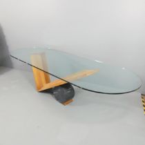 EMANUELLE ZENERE FOR CATTELAN ITALIA - A contemporary oval glass-topped dining table on a