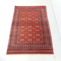 A red-ground Afghan rug. 190x126cm.