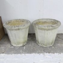 A pair of weathered composite garden pots. 36x32cm.