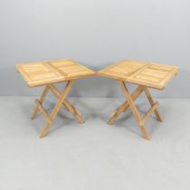 A modern pair of small teak folding garden tables. 50x50x50cm.