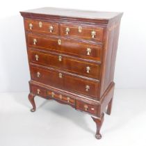 A George III walnut chest on stand raised on cabriole legs, width 94cm, height 127cm Veneer splits