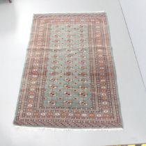 An antique blue-ground Afghan silk rug. 190x127cm.