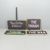 Four various black painted signs with rope surrounds. Dimensions for "The Trough" 63x52cm. 1x"The