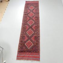 A red-ground Meshwani runner. 253x62cm.