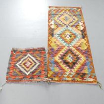 A Chobi Kilim runner, 150x63cm, and a similar mat, 47x50cm. (2)