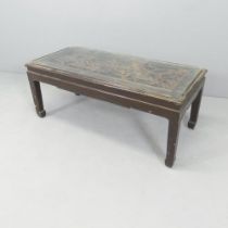 A Chinese opium table with glass top over carved decoration. 102x42x46cm.