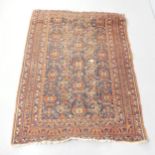 A red-ground Qashqai rug. 180x130cm. Well used condition. Areas of loss of pile, damage to fringes