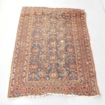 A red-ground Qashqai rug. 180x130cm. Well used condition. Areas of loss of pile, damage to fringes