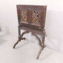 A Victorian gothic ebonised coaching table / folio stand. A/F. Dimensions (unfolded) 94x71x84cm.