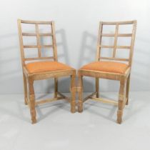 A pair of oak lattice back Cotswold school dining chairs in the manner of Heals. Good overall