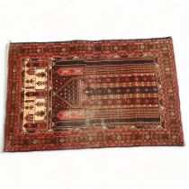 A red ground Beluchi wool prayer rug, 135cm x 87cm