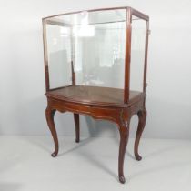 A Victorian mahogany two-section centre-standing museum display cabinet on stand, with side