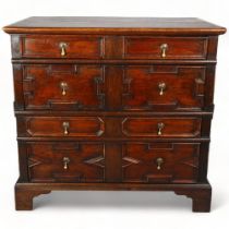 A 17th century oak Jacobian chest of drawers, with field geometric panel drawers and brass pear-drop