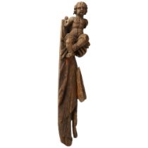A section of an antique carved wood ships figure head, depicting the Christ child being held,